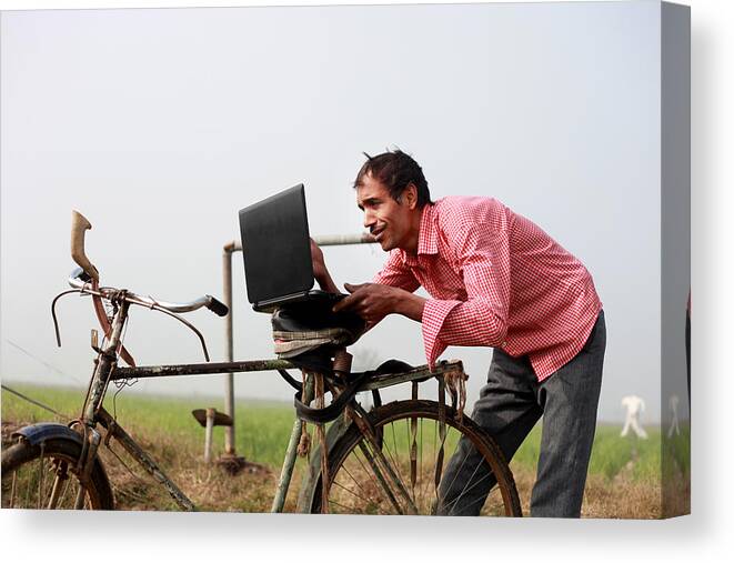 Farm Worker Canvas Print featuring the photograph Farmer using laptop in the field #2 by Pixelfusion3d
