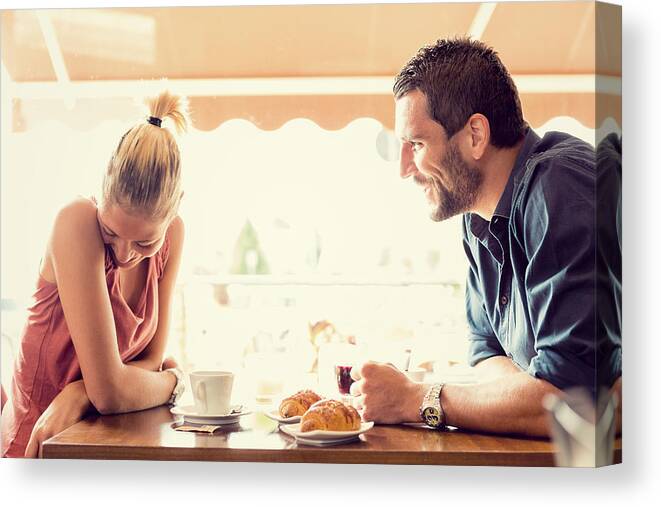 Young Men Canvas Print featuring the photograph Young couple has breakfast at italian café #2 by ZoneCreative