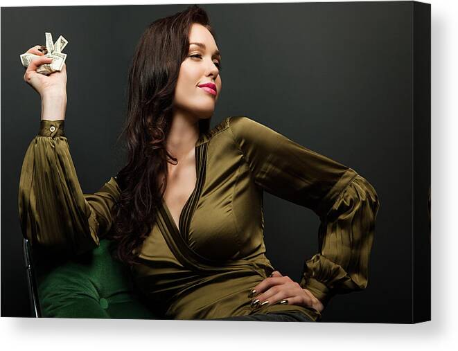 People Canvas Print featuring the photograph Young woman holding dollar bills #2 by Image Source
