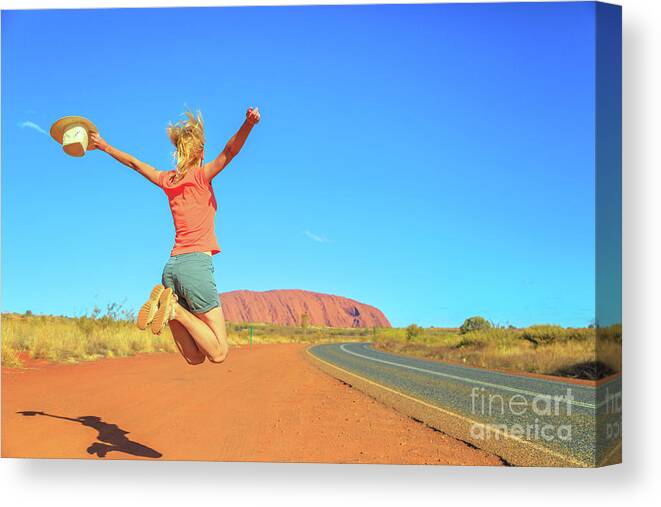 Australia Canvas Print featuring the photograph Uluru woman jumping #5 by Benny Marty