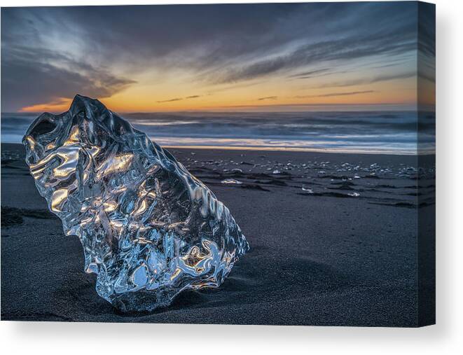 Arctic Canvas Print featuring the photograph A big block of ice on the beach at sunrise, near the Jokulsarlon lagoon in South Iceland, also calle by Anges Van der Logt