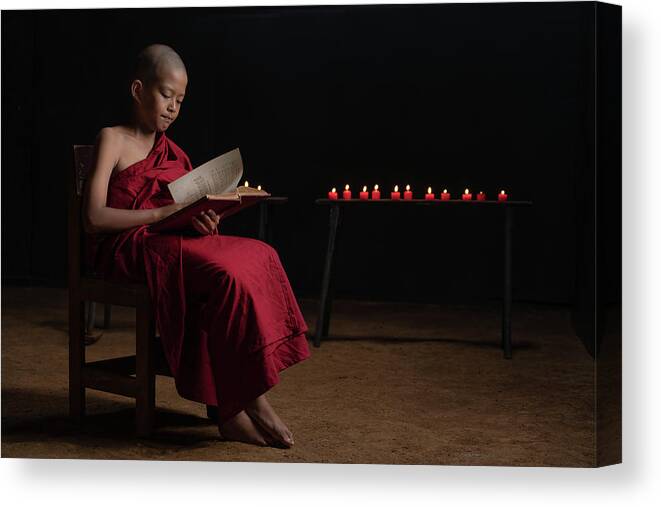 Novice Canvas Print featuring the photograph A novice monk reading by Anges Van der Logt