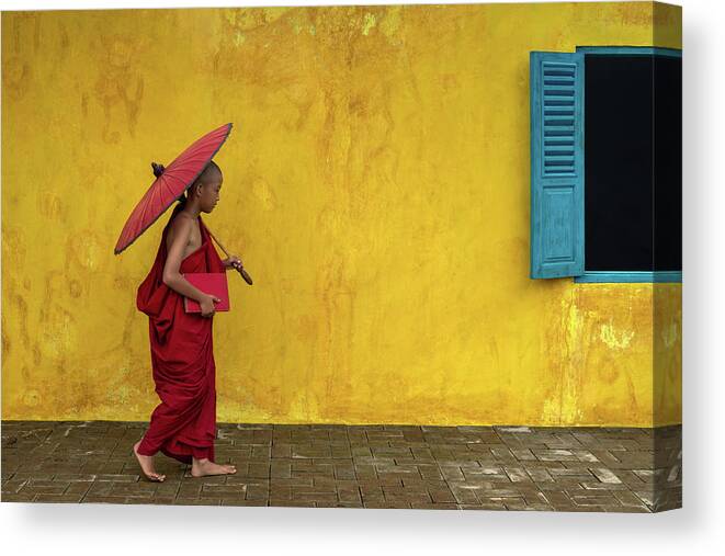 Novice Canvas Print featuring the photograph A novice monk walking by by Anges Van der Logt