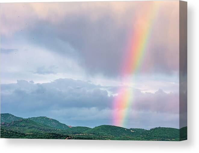 Rainbow Canvas Print featuring the photograph A Rainbow Over The Hills by Alexios Ntounas