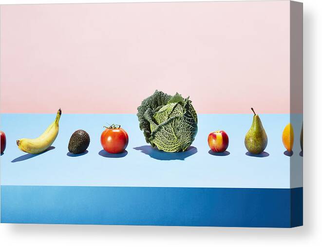 Diversity Canvas Print featuring the photograph A row of different fruits and vegetables on a table top by Richard Drury