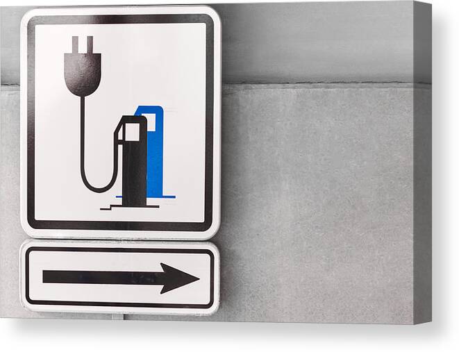 Environmental Conservation Canvas Print featuring the photograph A sign on the parking showed a charging point for electric car. by Volodymyr Kalyniuk