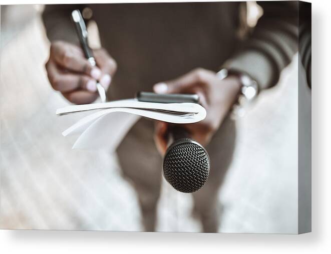 African Ethnicity Canvas Print featuring the photograph African Male Journalist Preparing Questions For Press Conference by AleksandarGeorgiev