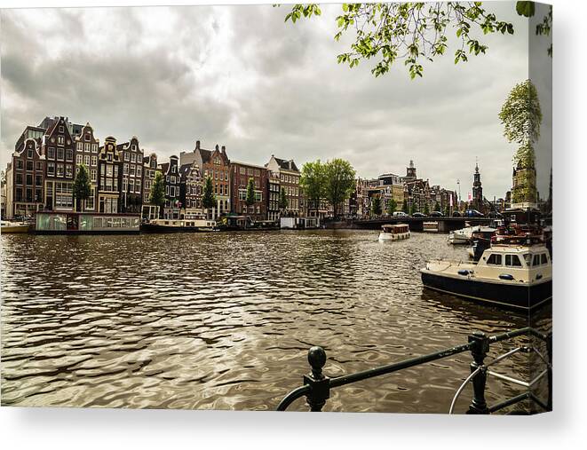Amstel Canvas Print featuring the photograph Amsterdam cityscape with Amstel river by Fabiano Di Paolo
