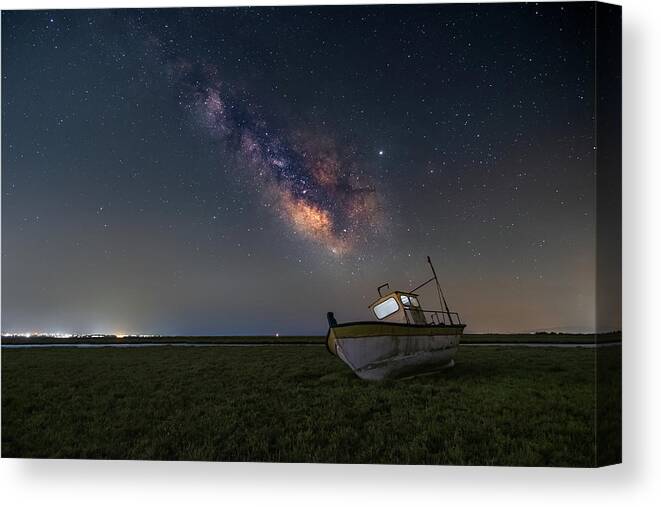 Milky Way Canvas Print featuring the photograph An old boat under the milkyway by Alexios Ntounas