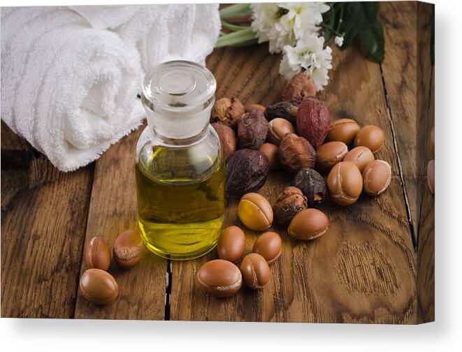 Nut Canvas Print featuring the photograph Argan oil with fruits by Luisapuccini