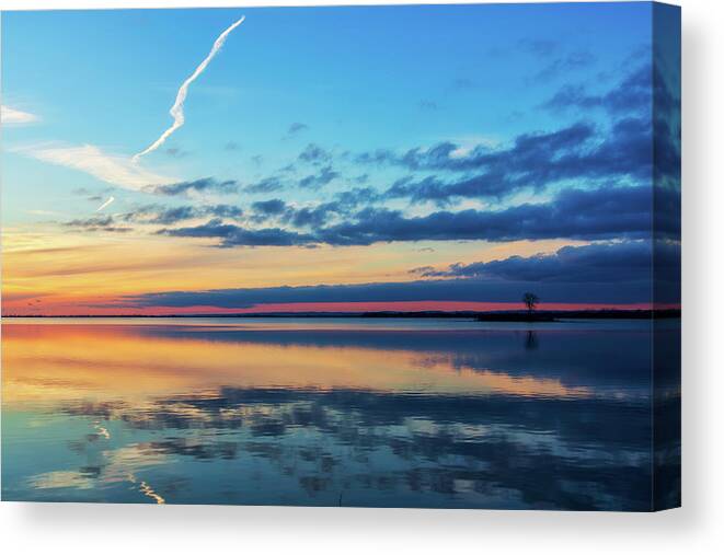Sundown Canvas Print featuring the photograph As the sun goes down on the water by Tatiana Travelways