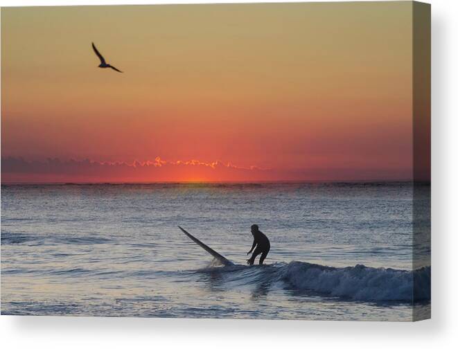 Sunrise Canvas Print featuring the photograph At Sunrise - Surfer in Ocean City New Jersey by Bill Cannon