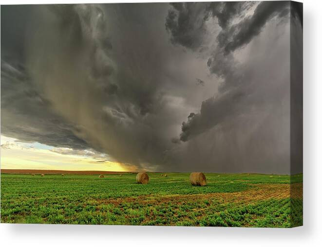 Bales Canvas Print featuring the photograph Baelstrom #2 - A Face in the Clouds - stormcloud above ND hay bales by Peter Herman