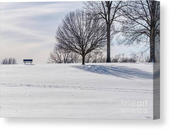 Snow Canvas Print featuring the photograph Bench On Snow Covered Hill by Jennifer White