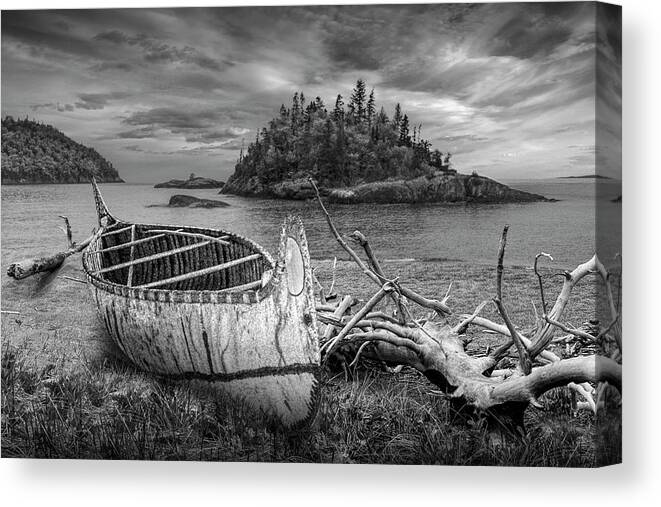 Art Canvas Print featuring the photograph Birch Bark Canoe ashore on Driftwood Beach in Black and White by Randall Nyhof