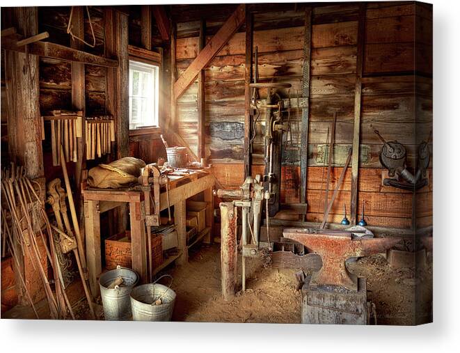 Blacksmith Canvas Print featuring the photograph Blacksmith - Shapes iron with an anvil and hammer by Mike Savad