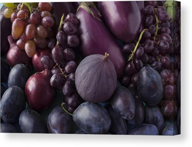 Immune System Canvas Print featuring the photograph Blue and purple food. Background of fruits and vegetables. Fresh figs, plums, onions, eggplant and grapes. Top view. by Kitamin
