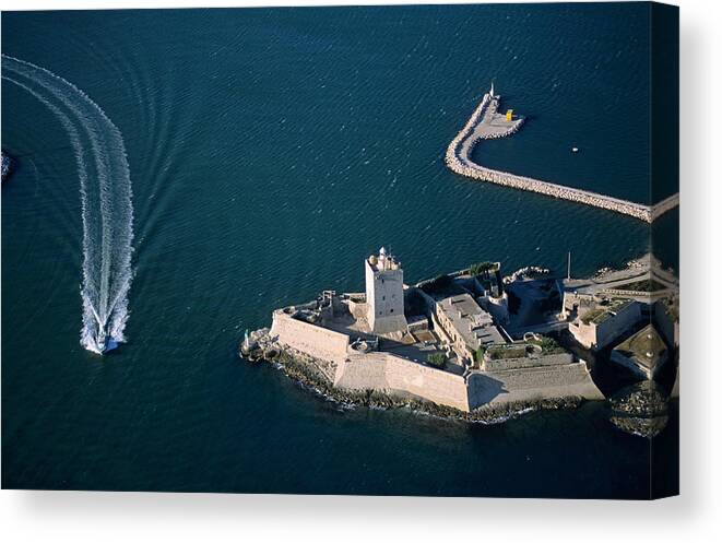 Wake Canvas Print featuring the photograph Boat passing along the fort of Fos-Sur-Mer, France (aerial view) by Sami Sarkis