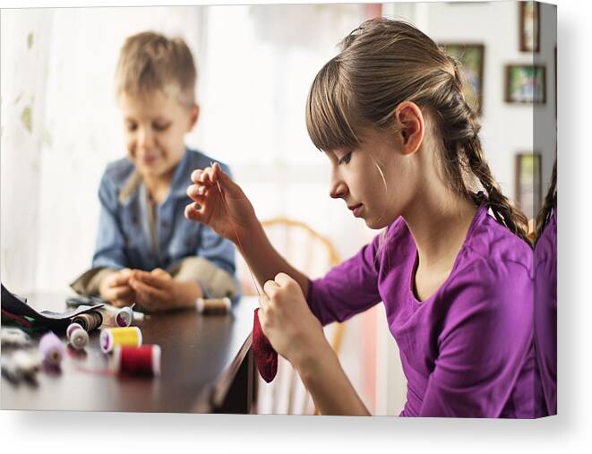 4-5 Years Canvas Print featuring the photograph Brother and sister crafting and sewing by Imgorthand