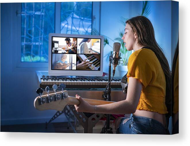People Canvas Print featuring the photograph Brunette teen musician singer girl singing and playing bass guitar teleconference by Mediterranean