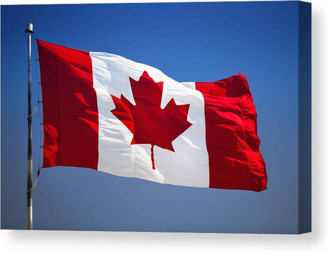Wind Canvas Print featuring the photograph Canada symbol on a flagpole by Pgiam