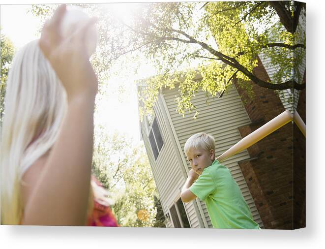 Child Canvas Print featuring the photograph Caucasian children playing baseball in backyard by JGI/Jamie Grill