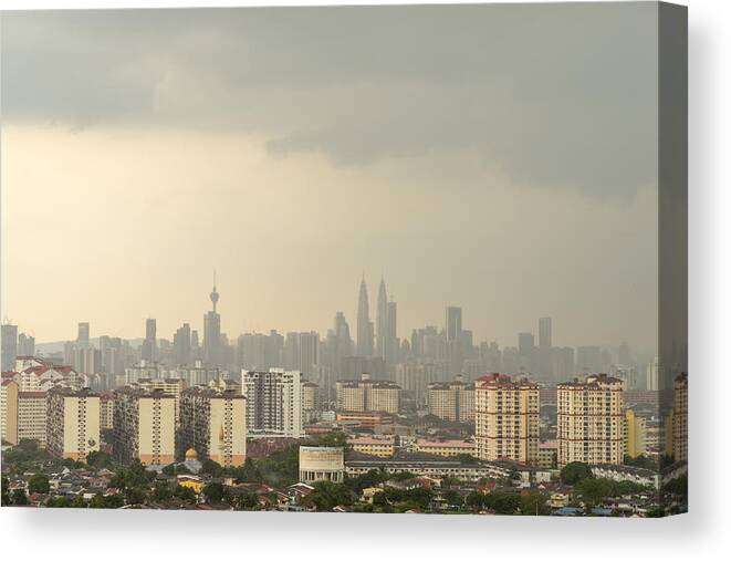 Corporate Business Canvas Print featuring the photograph Cloudy moments of downtown Kuala Lumpur with Petronas Twin Towers and KL Tower dominant the skyline. by Shaifulzamri