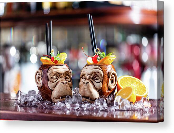 Cocktail Canvas Print featuring the photograph Coctail in monkey mugs on bar counter by Michal Bednarek