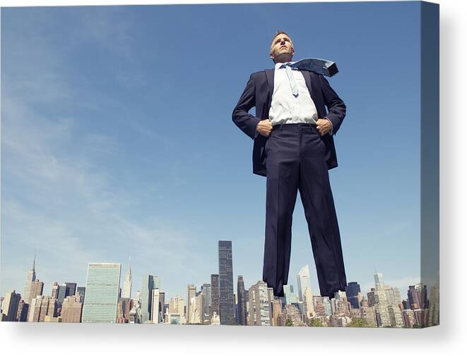 People Canvas Print featuring the photograph Confident Giant Businessman Standing Tall Over City Skyline by PeskyMonkey