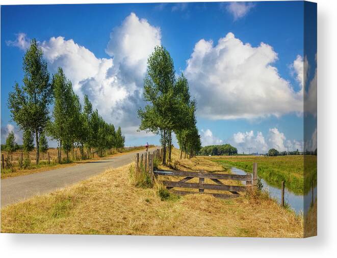 Clouds Canvas Print featuring the photograph Cycling in the Netherlands by Debra and Dave Vanderlaan