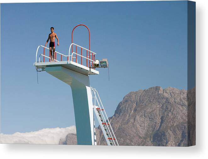 People Canvas Print featuring the photograph Diver standing on a diving board in a scenic location by Chris Ryan