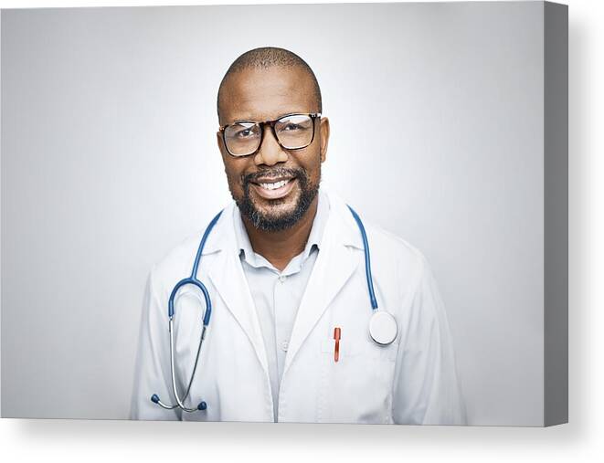 Expertise Canvas Print featuring the photograph Doctor wearing eyeglasses on white background by Morsa Images