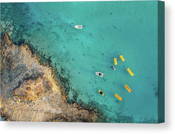 Seascape Canvas Print featuring the photograph Drone aerial of seascape with idyllic blue calm blue water. Fig tree bay beach Protaras Cyprus by Michalakis Ppalis
