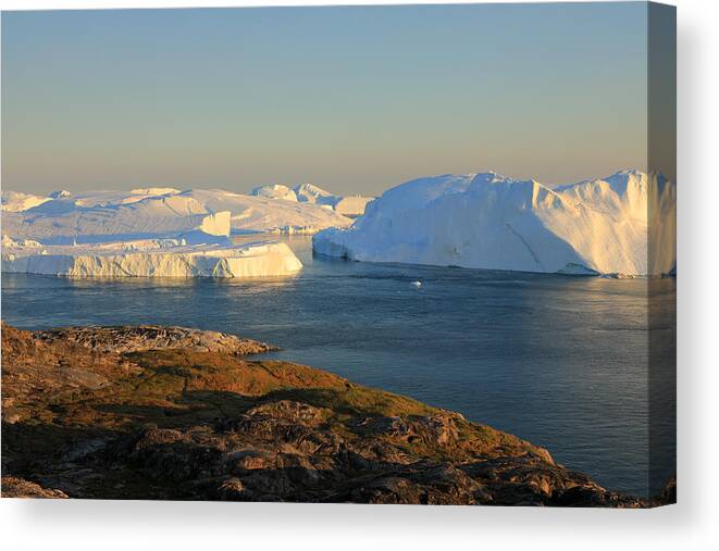 Scenics Canvas Print featuring the photograph Elevated view at huge icebergs in the Icefjord at late afternoon by Rainer Grosskopf