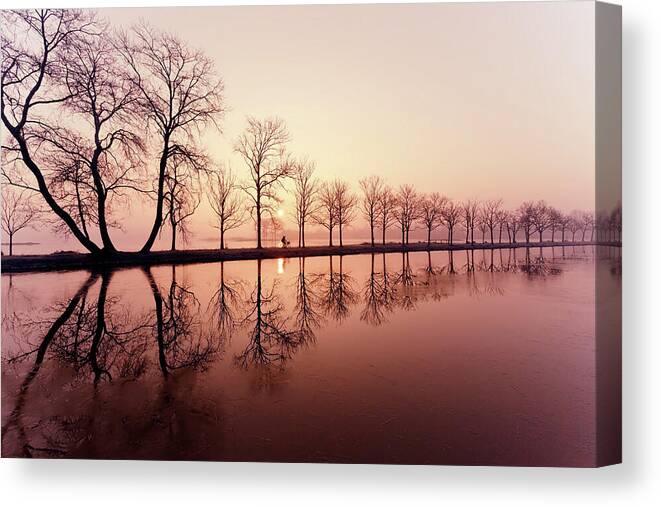 Sunrise Canvas Print featuring the photograph Endlessness - Silhouette reflected on an early morning sunrise by Roeselien Raimond