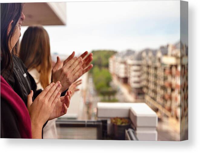 Young Men Canvas Print featuring the photograph Family applauding from the balcony of their home by Sol de Zuasnabar Brebbia