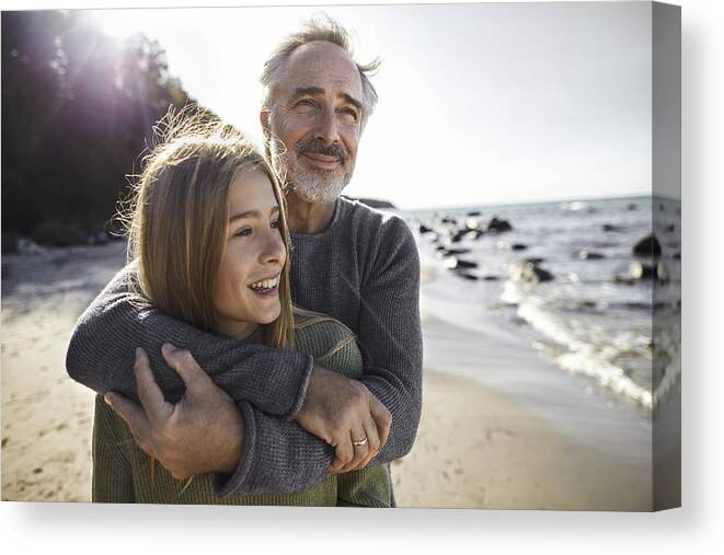 Sweater Canvas Print featuring the photograph Father hugging daughter on the beach by Oliver Rossi