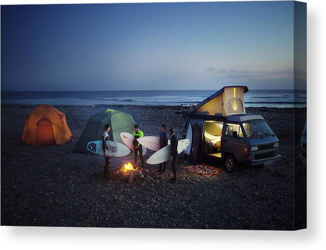 Tranquility Canvas Print featuring the photograph Friends with surfboard camping at beach against sky by Cavan Images