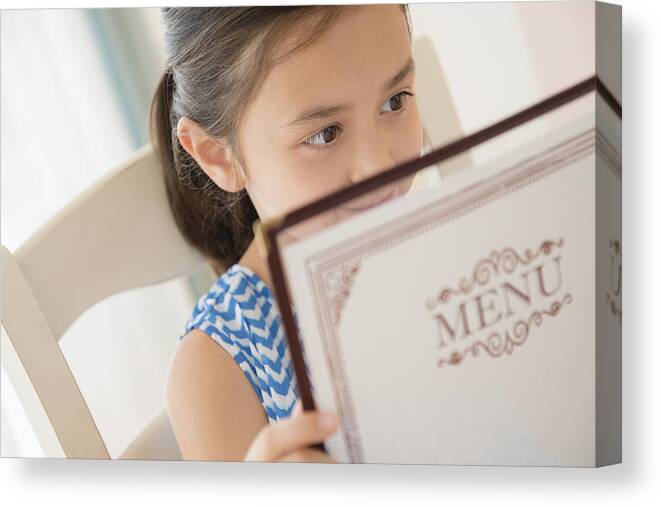 Tranquility Canvas Print featuring the photograph Girl reading menu in restaurant by JGI/Jamie Grill