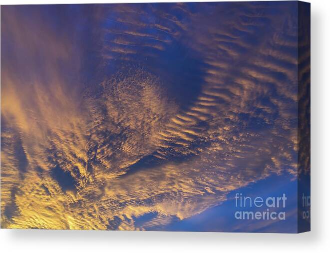 Clouds Canvas Print featuring the photograph Golden and dark blue cloudscape at sunset by Adriana Mueller