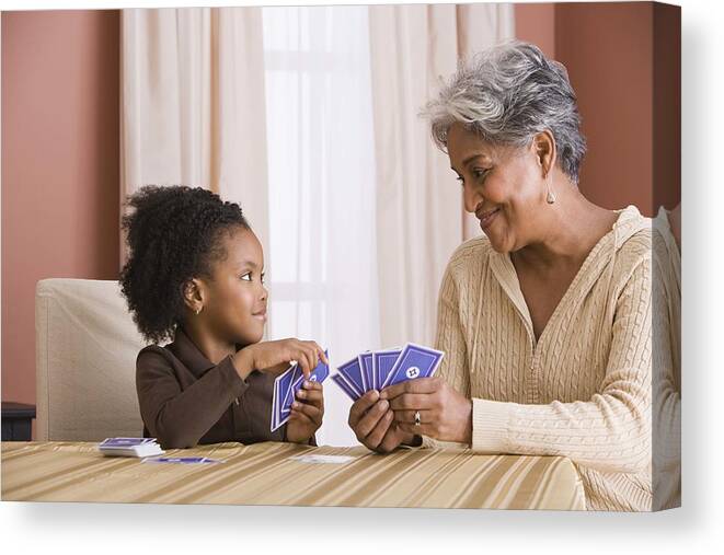 4-5 Years Canvas Print featuring the photograph Grandmother and granddaughter playing cards by Jupiterimages