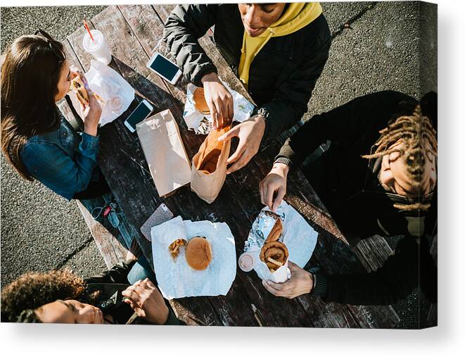 20-29 Years Canvas Print featuring the photograph Group of Young Adults Eating Fast Food by RyanJLane