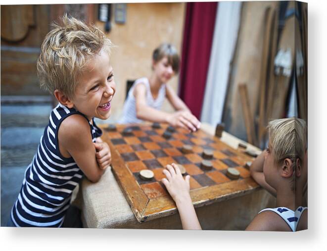 White People Canvas Print featuring the photograph Happy kids playing checkers in the street by Imgorthand