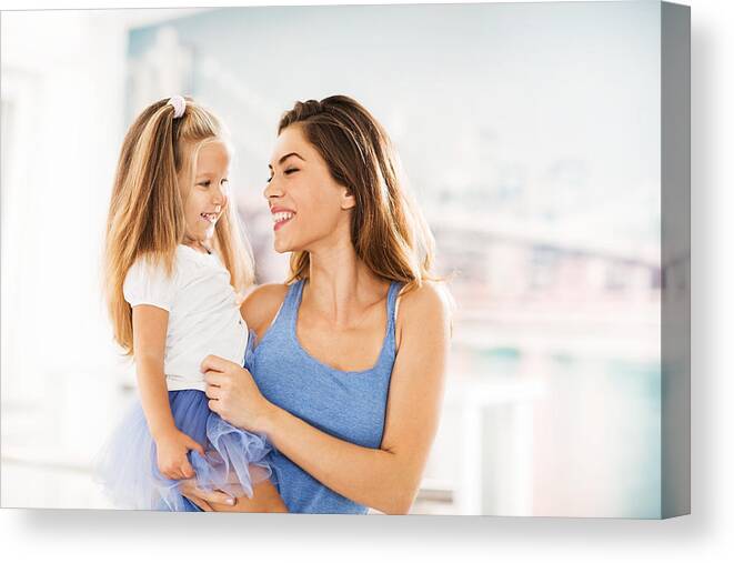 Child Canvas Print featuring the photograph Happy mother and daughter at home. by BraunS
