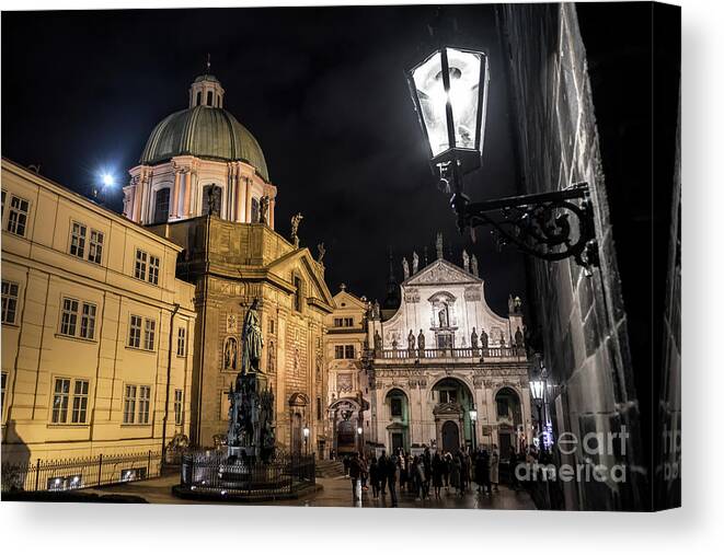 Ancient Canvas Print featuring the photograph Historic Buildings Beneath The Tower Of Charles Bridge In The Night In Prague In The Czech Republic by Andreas Berthold
