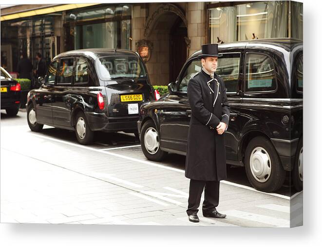 Working Canvas Print featuring the photograph Hotel Doorman in London by CaroleGomez