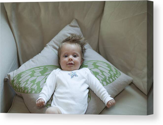 People Canvas Print featuring the photograph Infant girl lying on butterfly wing pillow by Noah Clayton