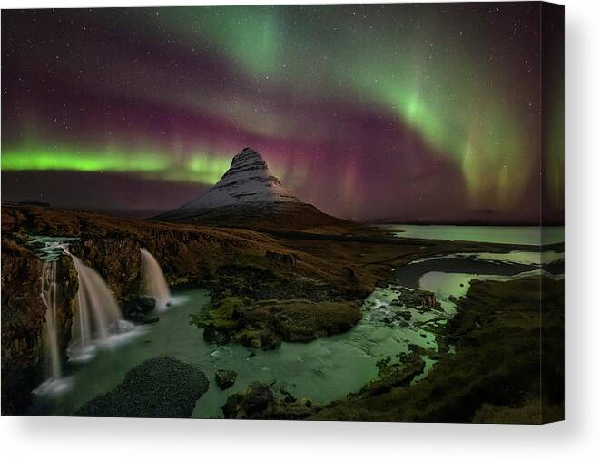 Northern Lights Canvas Print featuring the photograph Kirkjufellsfoss Greets the Northern Lights by Roman Kurywczak