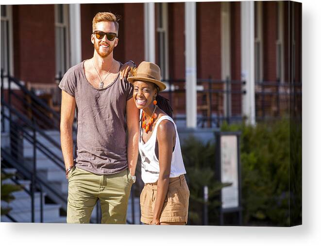Young Men Canvas Print featuring the photograph Laughing couple walking outdoors by Adam Hester