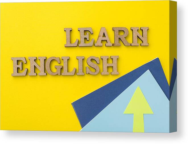 Education Canvas Print featuring the photograph Learn English, words in wooden letters with yellow background by Valeriy_G